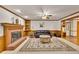 Cozy living room featuring a brick fireplace, hardwood trim, and a comfortable seating area at 2071 Habersham Cir, Covington, GA 30014