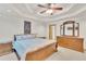 Main bedroom with tray ceilings, carpet flooring and decorative dresser at 2071 Habersham Cir, Covington, GA 30014