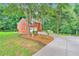Side view of a two-story brick home with a long driveway and garage at 2071 Habersham Cir, Covington, GA 30014