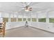 Bright sunroom with walls of windows, ceiling fan and exercise equipment at 2071 Habersham Cir, Covington, GA 30014