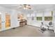 Bright sunroom with walls of windows, ceiling fan, and bar top seating at 2071 Habersham Cir, Covington, GA 30014