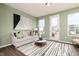 Bright living room with large windows, a cozy sofa, and stylish decor at 2682 Brookview Nw Ln, Atlanta, GA 30318