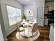 Cozy dining area with stylish round table, seating four, and filled with natural light at 5050 Roxton Ln, Douglasville, GA 30135