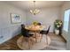 Modern dining room with stylish black chairs, round wooden table, chandelier, and elegant decor at 5050 Roxton Ln, Douglasville, GA 30135