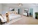 Spacious main bedroom featuring a tray ceiling, neutral decor, and access to an ensuite bathroom at 5050 Roxton Ln, Douglasville, GA 30135