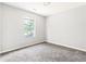 This bedroom offers plush carpeting and a sunny window, creating a comfortable space at 5484 Denny Dr, Atlanta, GA 30349