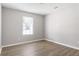 This bedroom features wood flooring and a bright window, perfect for a cozy retreat at 5484 Denny Dr, Atlanta, GA 30349