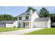 Well-maintained two-story home with a two-car garage and a long driveway offers classic suburban charm at 5484 Denny Dr, Atlanta, GA 30349