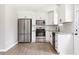 Modern kitchen with stainless steel appliances, white cabinets, and granite countertops is both functional and stylish at 5484 Denny Dr, Atlanta, GA 30349