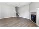 Bright living room features a fireplace, staircase, and sleek wood floors for a cozy and modern space at 5484 Denny Dr, Atlanta, GA 30349