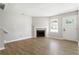 Inviting living room with a fireplace, light gray walls, and wood flooring creates a modern and comfortable atmosphere at 5484 Denny Dr, Atlanta, GA 30349