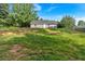 Expansive backyard with a charming home nestled amidst lush greenery and mature trees at 69 Southern Trace Way, Rockmart, GA 30153