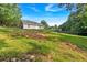 The secluded backyard, lined with lush greenery, offers a tranquil retreat and room for personalization at 69 Southern Trace Way, Rockmart, GA 30153