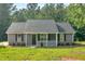 Charming single-story home with gray siding, black shutters and well-manicured lawn at 69 Southern Trace Way, Rockmart, GA 30153