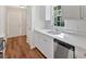 Well-lit kitchen featuring white cabinets, stainless steel appliances, and hardwood floors at 69 Southern Trace Way, Rockmart, GA 30153