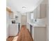 Modern kitchen with white cabinets, stainless steel appliances, and wood flooring at 69 Southern Trace Way, Rockmart, GA 30153