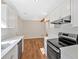 Bright kitchen showcasing white cabinets and appliances, complemented by wood-style flooring at 69 Southern Trace Way, Rockmart, GA 30153