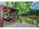 Outdoor deck area featuring a covered seating area and lush green surroundings at 706 Powder Springs Se St, Smyrna, GA 30080