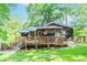 The home features a charming back deck, perfect for entertaining, with outdoor lighting and views of the lush yard at 706 Powder Springs Se St, Smyrna, GA 30080