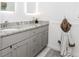 Bathroom featuring a dual sink vanity with gray cabinets, granite countertops, and modern fixtures at 706 Powder Springs Se St, Smyrna, GA 30080