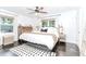 Bright bedroom featuring a ceiling fan, hardwood floors, and natural light from the large windows at 706 Powder Springs Se St, Smyrna, GA 30080