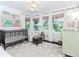 Adorable Bedroom with a crib, large windows, and natural light, perfect for a baby at 706 Powder Springs Se St, Smyrna, GA 30080