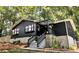 Charming home featuring dark exterior, stone foundation, pergola, and inviting front steps at 706 Powder Springs Se St, Smyrna, GA 30080