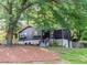 Beautiful exterior of home featuring dark facade, stone foundation and mature trees at 706 Powder Springs Se St, Smyrna, GA 30080