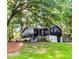 Beautiful exterior of home featuring dark facade, stone foundation and mature trees at 706 Powder Springs Se St, Smyrna, GA 30080