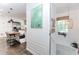 Hallway showcasing a glimpse of the kitchen, stairs to the basement, and white trim at 706 Powder Springs Se St, Smyrna, GA 30080