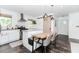 Stylish kitchen with white cabinetry, stainless steel appliances, and adjacent dining area at 706 Powder Springs Se St, Smyrna, GA 30080