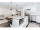 Open kitchen featuring white cabinets, granite countertops, island and seamless living area at 706 Powder Springs Se St, Smyrna, GA 30080