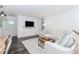 Modern living room featuring white walls, dark floors, and a comfortable sectional sofa at 706 Powder Springs Se St, Smyrna, GA 30080