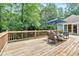 Wooden deck with seating and umbrella, perfect for enjoying outdoor gatherings at 14 Black Forest Run, Douglasville, GA 30134