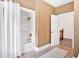 Neutral-colored bathroom with shower and tile floor is conveniently located near the stairs at 14 Black Forest Run, Douglasville, GA 30134
