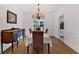 Elegant dining room features hardwood floors, a decorative chandelier, and a classic wooden sideboard at 14 Black Forest Run, Douglasville, GA 30134
