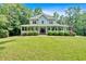 Charming two-story home with a spacious front porch and well-manicured landscaping at 14 Black Forest Run, Douglasville, GA 30134