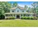 Charming two-story home featuring a welcoming wrap-around porch and well-manicured landscaping at 14 Black Forest Run, Douglasville, GA 30134