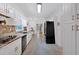Modern kitchen with white cabinets, granite countertops, black appliances, and stylish backsplash at 14 Black Forest Run, Douglasville, GA 30134