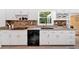 Bright kitchen featuring white cabinets, stone backsplash, and modern appliances at 14 Black Forest Run, Douglasville, GA 30134