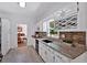 Well-lit kitchen with granite counters, white cabinets, a built-in wine rack, and modern fixtures at 14 Black Forest Run, Douglasville, GA 30134