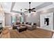 Spacious living room with fireplace, wood floors, tray ceiling with fans, and adjacent updated kitchen at 14 Black Forest Run, Douglasville, GA 30134