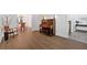 Elegant living room featuring sleek hardwood floors, a decorative piano, and a view of the formal dining room at 14 Black Forest Run, Douglasville, GA 30134