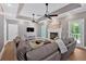 Open-concept living room featuring a fireplace, ample seating, tray ceiling, and easy access to the outdoors at 14 Black Forest Run, Douglasville, GA 30134