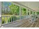 Charming porch with rocking chairs overlooking a manicured lawn and scenic views at 14 Black Forest Run, Douglasville, GA 30134