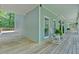Wraparound porch showing seating, lighting, and wood floors at 14 Black Forest Run, Douglasville, GA 30134