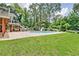 Expansive backyard with inviting pool featuring a slide, set amidst lush greenery and mature trees at 522 Golfview Dr, Peachtree City, GA 30269
