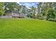 Sprawling backyard with lush green lawn and stunning in-ground pool, perfect for outdoor living at 522 Golfview Dr, Peachtree City, GA 30269