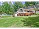 Spacious backyard featuring a pool with a slide, a deck, and lush lawn, perfect for outdoor entertainment and relaxation at 522 Golfview Dr, Peachtree City, GA 30269