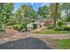 Lush backyard with bridge, a pool in the distance, and mature trees, creating a private oasis for relaxation and enjoyment at 522 Golfview Dr, Peachtree City, GA 30269